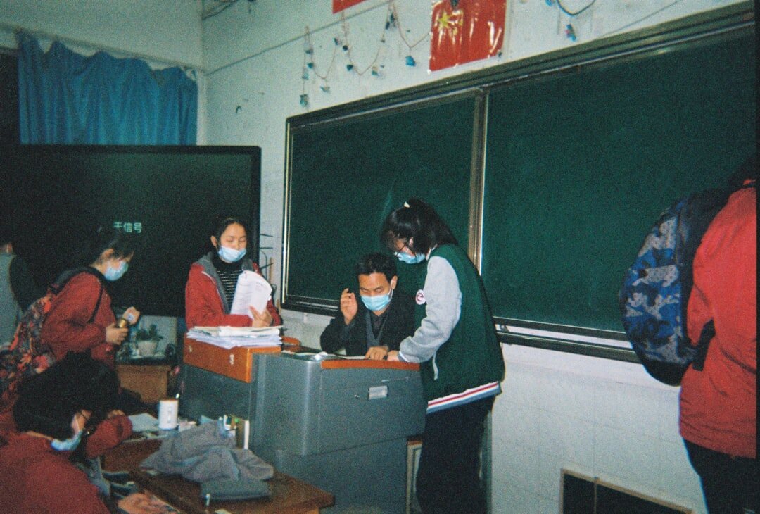 Mexican students coding together in a bright classroom