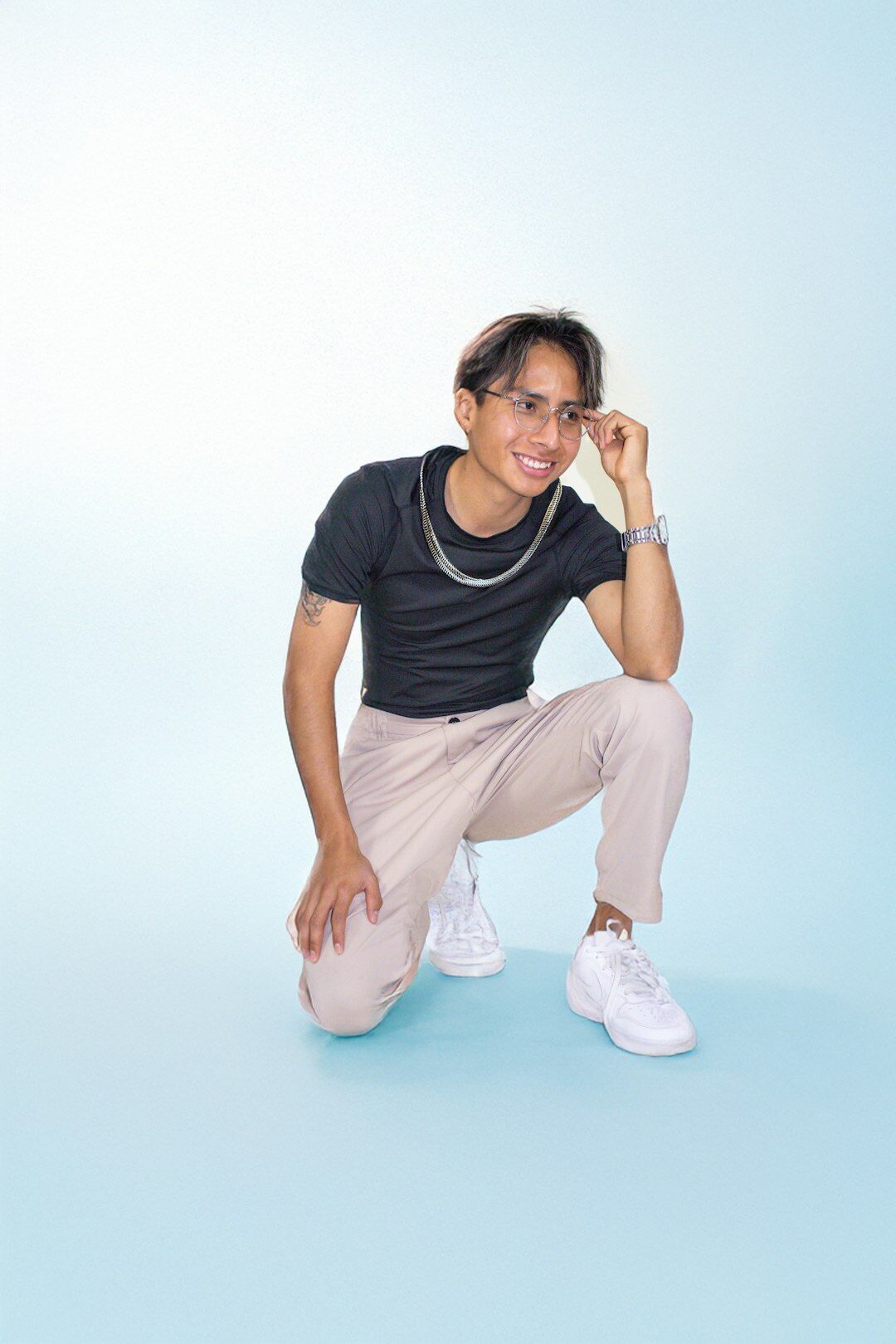 Studio portrait of a young Mexican man programming instructor smiling