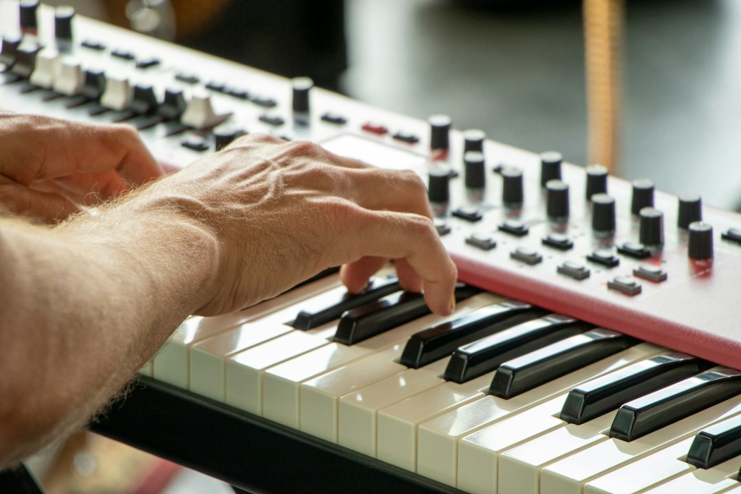 Close-up of a Mexican person's hands typing on a laptop keyboard