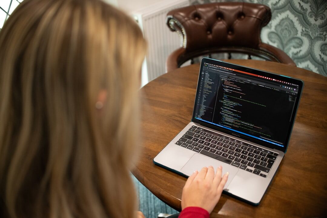 person coding on laptop